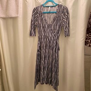 Fun and flattering geometric print black and white faux wrap dress